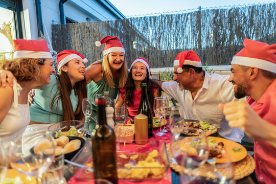 Diverse family and friends celebrating christmas dinner together