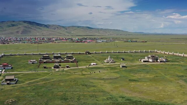 Aerial view of Erdene Zuu Monastery with its historic white walls and stupas set against the vast green Mongolian steppe in Kharkhorin, Ovorkhangai, Mongolia.