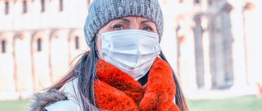 Coronavirus outbreak emergency. Woman visiting landmark wearing protective masks