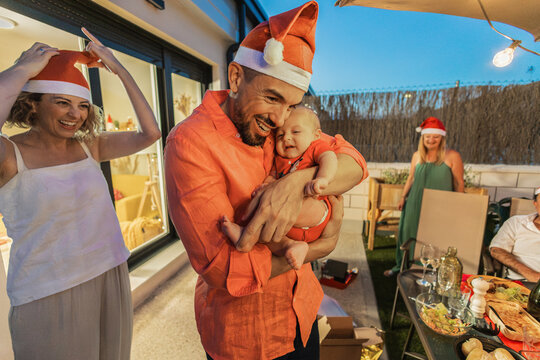 Happy family celebrating christmas holidays on outdoor terrace