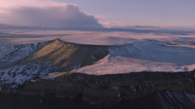 Aerial view of the snowy plateau and dramatic cliffs at the Morley Nelson Snake River Birds of Prey National Conservation Area in Murphy, Idaho, United States.