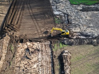 Construction machinery during route construction – aerial view showing wheel loader and excavator during earthworks © keBu.Medien