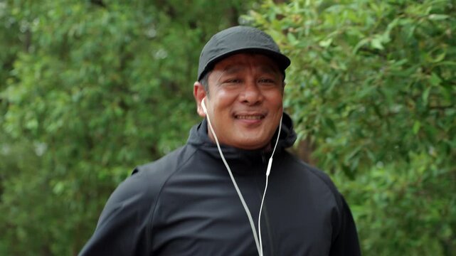 Happy active senior man jogging in nature after retirement. Healthy aging, fitness. Longevity outdoor lifestyle, preventive health, retirement happiness. Life insurance and financial security concept.