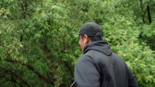 Happy active senior man jogging in nature after retirement. Healthy aging, fitness. Longevity outdoor lifestyle, preventive health, retirement happiness. Life insurance and financial security concept.