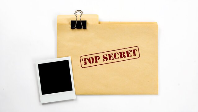 Top secret document envelope with instant photograph and binder clip on white background