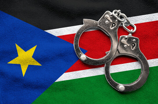 Flag of Flag of South Sudan and police handcuffs. Crime and offenses in country Concept
