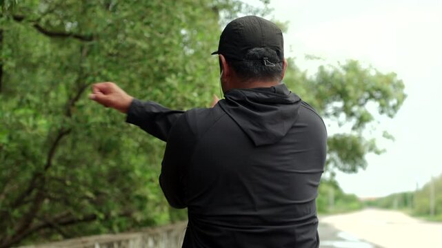 Happy active senior man warming up and stretching outdoors before exercise. Healthy aging, fitness. Longevity retirement lifestyle, preventive health, life insurance and joyful life after retirement.
