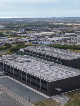 Aerial view of a large industrial data center facility with flat roofs and HVAC units situated in a commercial area in Drogheda, County Louth, Ireland.