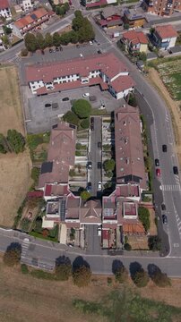 Top-down drone view of streets, houses and rooftops in Mediglia near Milan, capturing the residential landscape and everyday suburban character of Lombardy.
