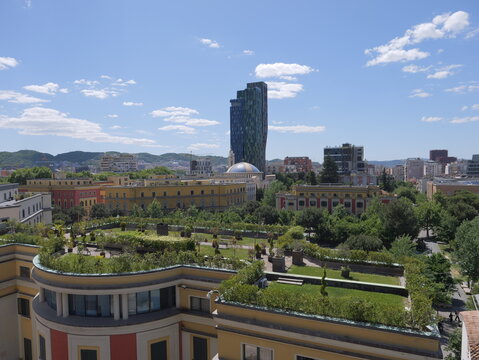 View of the cityscape of Tirane, featuring a green roof, the dome of the Et'hem Bey Mosque, and a modern skyscraper Tirane, Tirana County, Albania.
