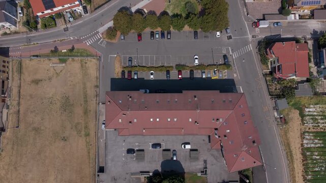 Top-down drone view of streets, houses and rooftops in Mediglia near Milan, capturing the residential landscape and everyday suburban character of Lombardy.