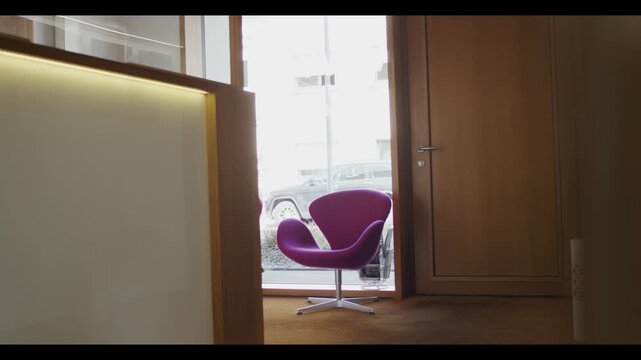 Purple lounge chair beside office entrance door