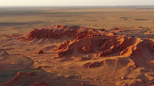 Aerial view of the red sandstone formations of the Flaming Cliffs in the Gobi Desert landscape near Bulgan, Omnogovi, Mongolia.