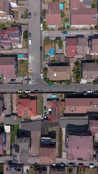 Top-down drone view of streets, houses and rooftops in Mediglia near Milan, capturing the residential landscape and everyday suburban character of Lombardy.