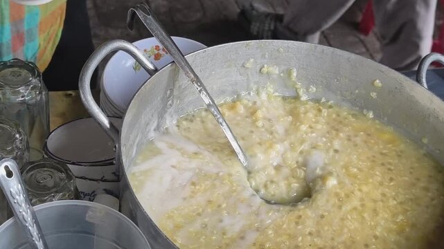 Traditional Vietnamese Sweet Dessert Being Topped with Coconut Milk at a Street Food Stall