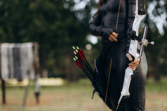 Archer holding recurve bow and arrows ready for practice