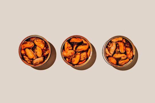 three tins of mejillones en escabeche in a row