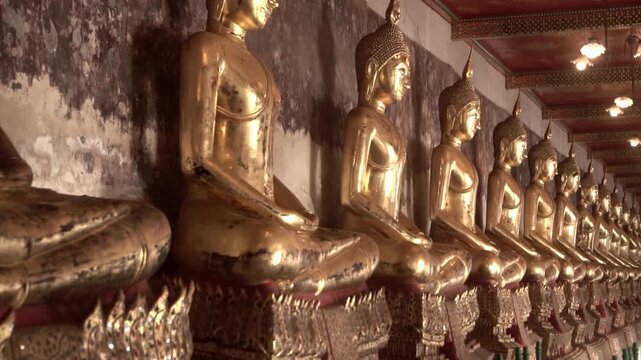 Row of ancient buddha statues in buddhist temple