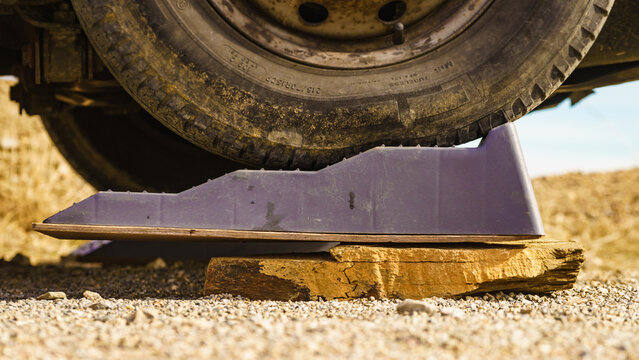 Camper using leveling block and stone for level