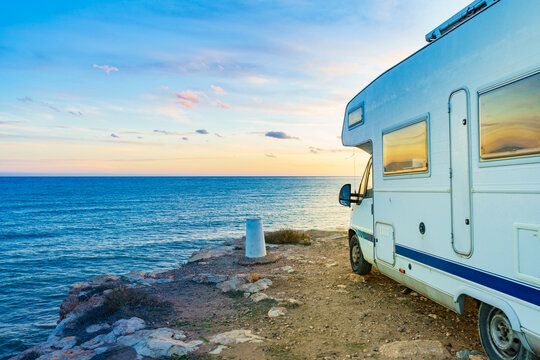 Caravan recreational vehicle camping on sea shore.