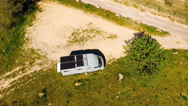 Caravan solar panels on roof camping on nature. Aerial view
