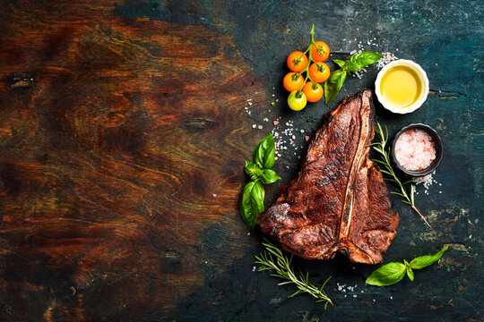 T-bone black agus steak with sea salt, butter and spices. Juicy steak grilled. Top view.