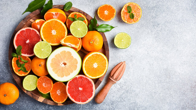 Assortment of colored citrus fruits: tangerine, grapefruit, lime and orange. Top view. Citrus fruits.