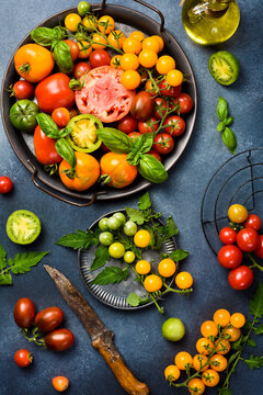 Fresh heirloom tomatoes background, organic produce at a Farmer's market. Tomatoes rainbow.