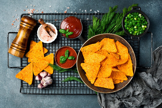 Crispy nachos chips with paprika in a bowl. Salty Mexican snacks.