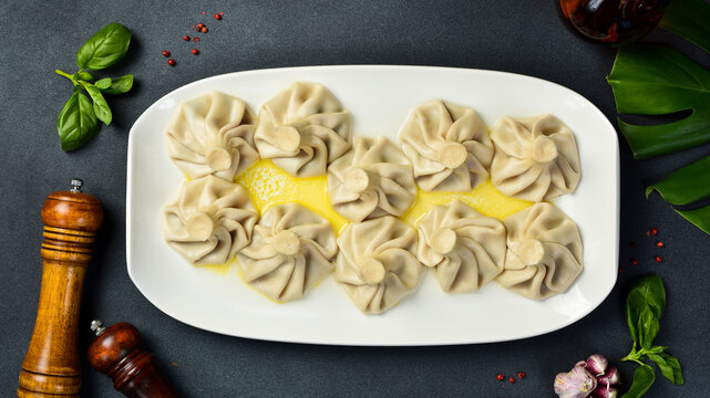 Georgian dumplings Khinkali with meat and red pepper, on plate. Top view. Close-up.