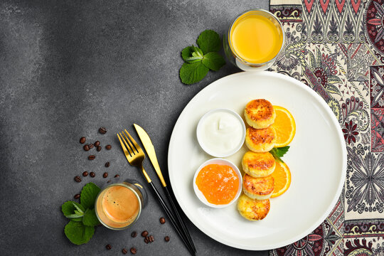 Breakfast. Cheese pancakes with orange jam and sour cream. Healthy meal.
