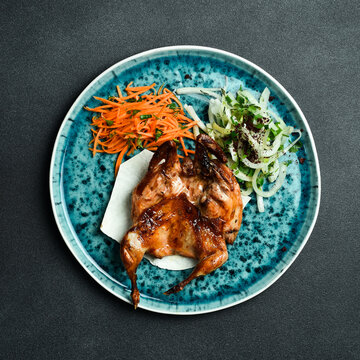 Grilled quail with onions and pita bread. Barbecue menu. Free space for text. Close up.