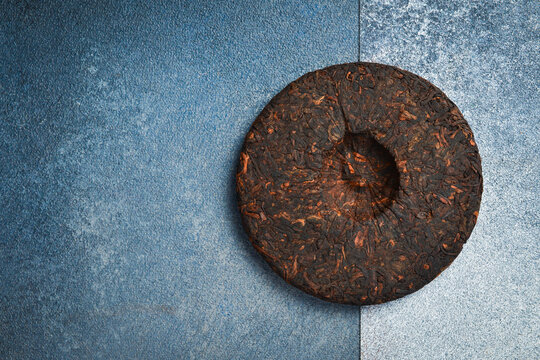 Fermented Pu-erh tea disc. Chinese traditional drink.
