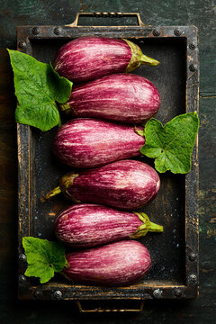 Organic fresh eggplants in a wooden box. Top view. Rustic style. Top view.