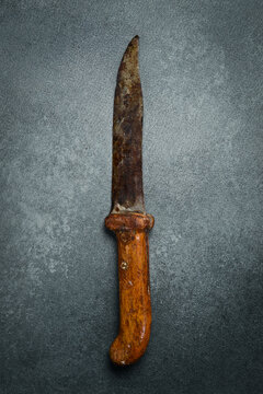 Old vintage kitchen knife. On concrete background. Top view.