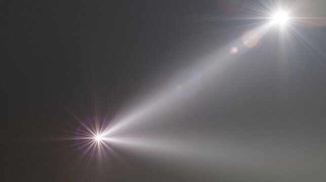Bright lens flare with light beams and bokeh on dark background. Used for creative effects and design.