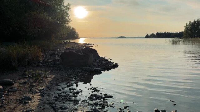 Exposed Rocky Lake Shore at Low Water Level in Evening Sun