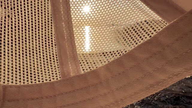 Sunlight Through White Cap Mesh with Lake Shore Behind