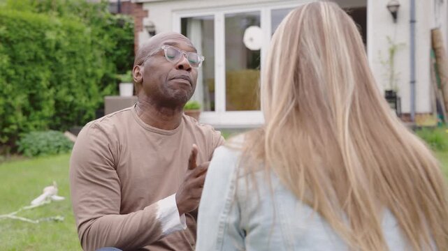 Conversation between two people in a garden setting discussing daily life and personal matters