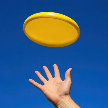 Flying disc frozen in mid air against a bright blue sky