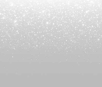 Falling snow particles with sparkling highlights and winter light.