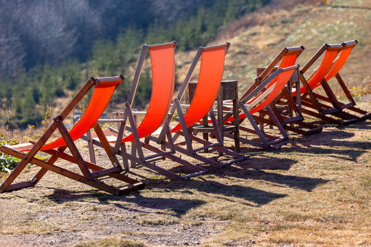 View of orange deck chairs arranged on a grassy hillside at Stara planina in Babin zub, Pirot District, Serbia.