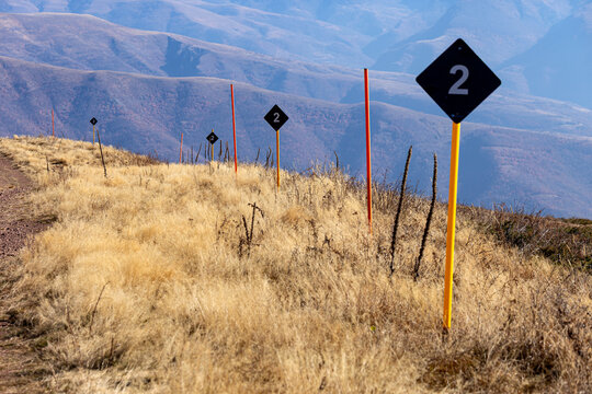 View of trail markers with the number two along a grassy mountain ridge at Stara planina, Babin zub, Pirot District, Serbia.