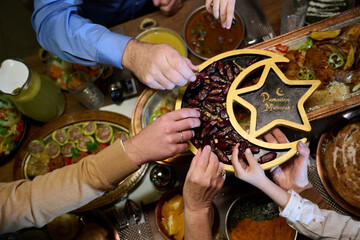Fototapeta premium Family Sharing Dates at Ramadan Iftar Dinner Ramadan Mubarak Celebration With Loved Ones