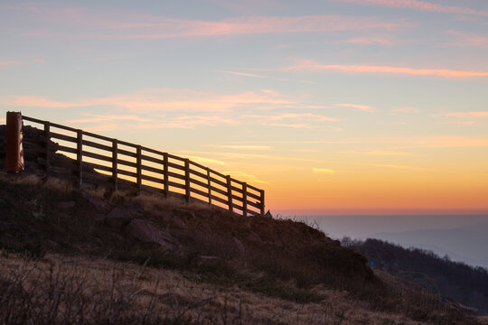 View of Stara planina at sunset with a wooden fence on the hillside in Babin zub, Pirot District, Serbia.