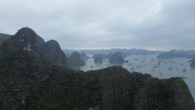 Panoramic drone shot of Ha Long Bay limestone karsts protruding from blue sea, Vietnam