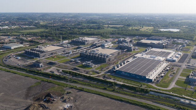 Aerial view of the Google data center complex with large industrial buildings and cooling infrastructure in Saint-Ghislain, Region wallonne, Belgium.