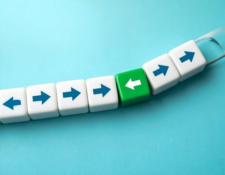 A row of white cubes with blue arrows moving right, one green cube reversing direction