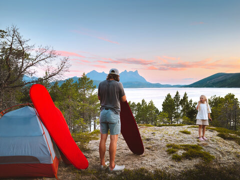 Family father and child setting camping gear in mountains travel vacations tour outdoor, parent and kid hiking in Norway together adventure trip eco tourism summer holidays in the wild