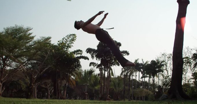 Dramatic parkour combo with a cinematic time ramp effect. Slow motion 1000fps, capturing the flow from a handstand to a high backflip with impressive hang time. Concept: cinematic dramatic action flow